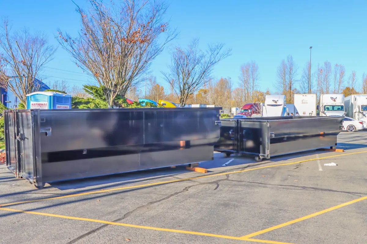 Professional dumpster rental service with roll-off container on residential driveway in Raritan